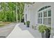Elegant white exterior with arched windows, stylish planters, and inviting bench seating at 135 Adams Park Dr, Fayetteville, GA 30214