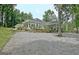 Exterior of home featuring a well-manicured lawn, white siding, covered patio, and natural landscape at 135 Adams Park Dr, Fayetteville, GA 30214