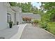 Elegant white home featuring well-manicured landscaping, brick driveway, and a welcoming entrance at 135 Adams Park Dr, Fayetteville, GA 30214