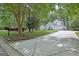 Charming home with a long driveway, lush landscaping, and mature trees, blending elegance with natural beauty at 135 Adams Park Dr, Fayetteville, GA 30214