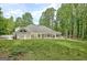 Home exterior featuring lush green lawn and outdoor living space at 135 Adams Park Dr, Fayetteville, GA 30214