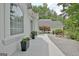 Elegant white home featuring well-manicured landscaping, brick driveway, and a welcoming entrance at 135 Adams Park Dr, Fayetteville, GA 30214