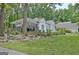 Charming exterior features a covered patio, manicured lawn, and elegant architectural details at 135 Adams Park Dr, Fayetteville, GA 30214