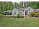 Elegant white home with a red door and stone landscaping accents at 135 Adams Park Dr, Fayetteville, GA 30214