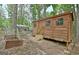 Wooden outbuilding with rustic design surrounded by a natural wooded landscape at 135 Adams Park Dr, Fayetteville, GA 30214