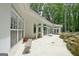 Covered patio space with white exterior and rock landscaping at 135 Adams Park Dr, Fayetteville, GA 30214