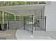 Covered patio with a metal fence, stone wall and an open gate at 135 Adams Park Dr, Fayetteville, GA 30214