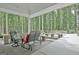 Inviting patio with seating and tranquil views of the wooded backyard at 135 Adams Park Dr, Fayetteville, GA 30214