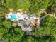 An aerial view displays a beautiful home nestled among lush trees and landscaping at 204 Clear Springs Ln, Peachtree City, GA 30269