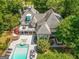 Aerial view of a home showcasing the pool, deck, and landscaped backyard at 204 Clear Springs Ln, Peachtree City, GA 30269