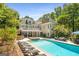 A luxurious backyard featuring a pool, hot tub, and lounge area perfect for outdoor enjoyment at 204 Clear Springs Ln, Peachtree City, GA 30269