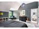 Comfortable bedroom featuring a gray accent wall, black dresser and an art piece of soccer star Pele at 204 Clear Springs Ln, Peachtree City, GA 30269