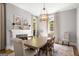 Bright dining room with fireplace, elegant chandelier, large windows, neutral color palette, and hardwood floors at 204 Clear Springs Ln, Peachtree City, GA 30269