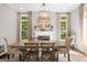Bright dining room with elegant chandelier, fireplace, large windows, neutral color palette, and hardwood floors at 204 Clear Springs Ln, Peachtree City, GA 30269