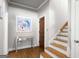 Bright entryway with wooden stairs, gorgeous artwork and a mirrored table at 204 Clear Springs Ln, Peachtree City, GA 30269