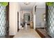 Elegant foyer showcasing travertine floors, chandelier, staircase and an arched doorway leading to the living room at 204 Clear Springs Ln, Peachtree City, GA 30269