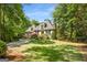 Well-manicured front lawn and mature trees beautifully frame this home with a dormer window and stone accents at 204 Clear Springs Ln, Peachtree City, GA 30269