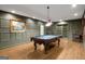 Spacious game room features a pool table, decorative painting, and paneled walls at 204 Clear Springs Ln, Peachtree City, GA 30269