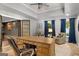 Home office with large desk, chair, hardwood floors, and ample natural light at 204 Clear Springs Ln, Peachtree City, GA 30269