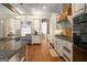 Expansive kitchen with granite countertops, stainless appliances, custom cabinetry and hardwood floors at 204 Clear Springs Ln, Peachtree City, GA 30269