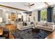 Open concept living room with views into the eat-in kitchen, large windows and comfortable seating at 204 Clear Springs Ln, Peachtree City, GA 30269