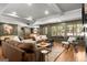 Spacious living room with a large sectional sofa, multiple windows, and hardwood floors at 204 Clear Springs Ln, Peachtree City, GA 30269
