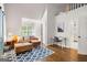 Cozy living room with hardwood floors, stylish blue rug, and lots of natural light at 204 Clear Springs Ln, Peachtree City, GA 30269