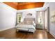 Bright main bedroom with tray ceiling, hardwood floors, and serene ambiance at 204 Clear Springs Ln, Peachtree City, GA 30269