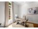Bright office space with wooden desk, hardwood floors, neutral rug and oversized window allowing ample natural light at 204 Clear Springs Ln, Peachtree City, GA 30269