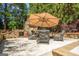 A stone outdoor fireplace with seating provides an inviting space for relaxation and entertaining at 204 Clear Springs Ln, Peachtree City, GA 30269