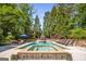 Inviting backyard pool and spa area with lounge chairs and lush landscaping at 204 Clear Springs Ln, Peachtree City, GA 30269