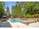 Inviting backyard pool and spa area with lounge chairs and lush landscaping at 204 Clear Springs Ln, Peachtree City, GA 30269