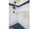 Clean shower with white tiles, contrasting blue floor tiles, and a shower caddy at 204 Clear Springs Ln, Peachtree City, GA 30269