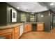 Wet bar area with wine cooler, granite countertop, wood cabinets, and sink at 204 Clear Springs Ln, Peachtree City, GA 30269