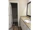 Bathroom featuring a granite countertop, white vanity, and a view of the shower/tub combo at 495 Mcgiboney Ln, Covington, GA 30016