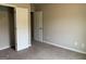 Neutrally painted bedroom featuring plush carpet, electrical outlets and two white doors at 495 Mcgiboney Ln, Covington, GA 30016