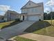 Two story house with a long concrete driveway and an attached garage at 495 Mcgiboney Ln, Covington, GA 30016