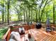 Inviting wooden deck with outdoor seating, grill and wooded view at 110 Cedar Creek Ct, Fayetteville, GA 30215