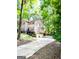 Two-story home with a two-car garage featuring a long driveway surrounded by mature trees at 110 Cedar Creek Ct, Fayetteville, GA 30215