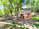 Expansive backyard with mature trees, wooden deck, patio, and fire pit at 110 Cedar Creek Ct, Fayetteville, GA 30215