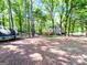 Large private backyard with mature trees, wood deck, and lawn at 110 Cedar Creek Ct, Fayetteville, GA 30215
