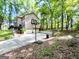 Spacious backyard and driveway with a basketball hoop, featuring a two-car garage at 110 Cedar Creek Ct, Fayetteville, GA 30215