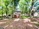 Wooded backyard with a wooden deck and a two-story home at 110 Cedar Creek Ct, Fayetteville, GA 30215