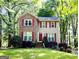 Charming two-story home with red shutters and a well-manicured lawn and mature landscaping at 110 Cedar Creek Ct, Fayetteville, GA 30215
