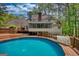 A lovely backyard pool featuring a wooden deck and screened-in porch, perfect for outdoor entertaining at 3341 Deer Hollow Sw Trl, Conyers, GA 30094