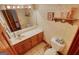 Traditional bathroom featuring a vanity, large mirror, and neutral-toned tiles at 3341 Deer Hollow Sw Trl, Conyers, GA 30094