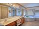 Large bathroom with double vanity, jacuzzi tub, and patterned wallpaper at 3341 Deer Hollow Sw Trl, Conyers, GA 30094