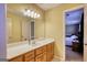 Bright bathroom featuring a large mirror, vanity, and a connecting room at 3341 Deer Hollow Sw Trl, Conyers, GA 30094