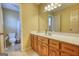 Well-lit bathroom featuring a large mirror, vanity, and a shower/tub combo at 3341 Deer Hollow Sw Trl, Conyers, GA 30094