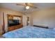 Inviting bedroom with a TV, dresser and a colorful patterned comforter set at 3341 Deer Hollow Sw Trl, Conyers, GA 30094